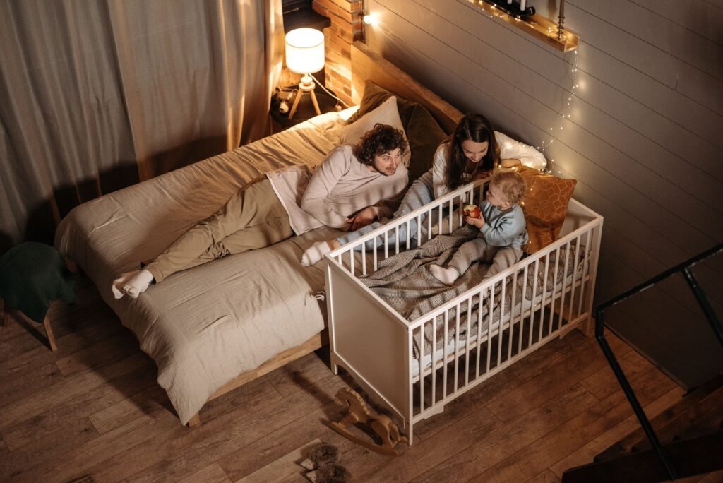 Bebê recém-nascido dormindo tranquilamente no quarto ao lado da cama dos pais